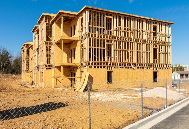 a close-up of temporary chain link fences enclosing a job site, signaling progress in the project's development in Farmville